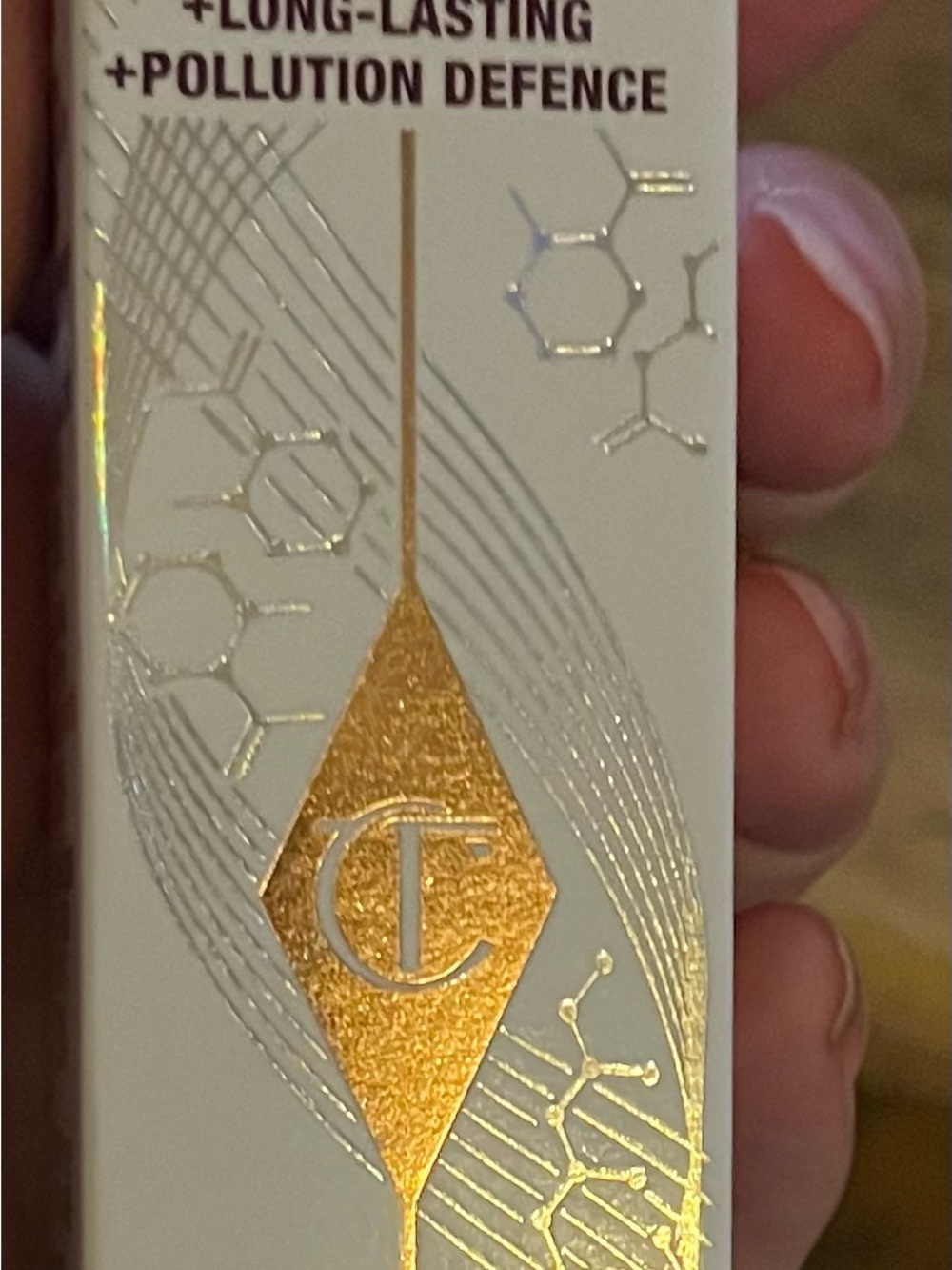 Charlotte Tilbury White and Gold Makeup Accessory with Metallic Logo